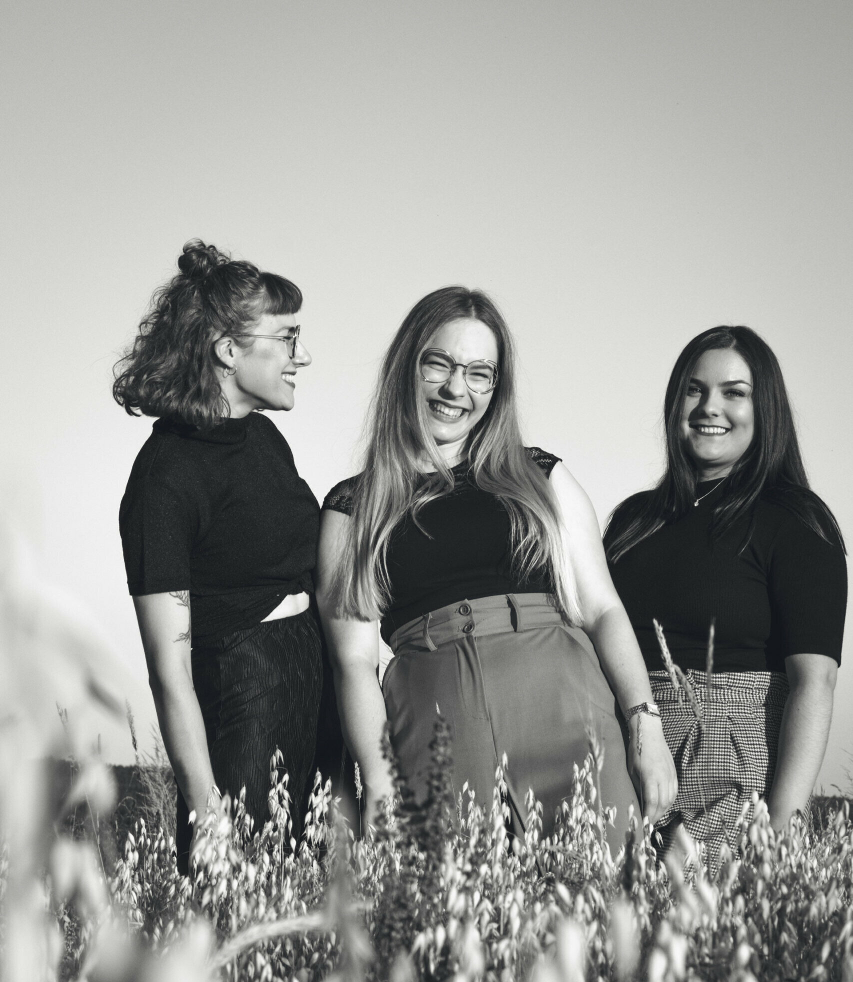 Drei Freundinnen lachen im Kornfeld